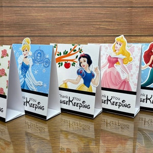 May include: Five Disney princess-themed thank you cards for housekeeping. The cards feature Belle, Cinderella, Snow White, Aurora, and Ariel. Each card has a different background and says "Thank You" with the word "Housekeeping" underneath.