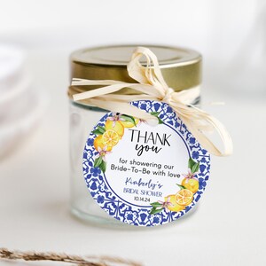 May include: Round blue and white patterned thank you tag with lemons and flowers. The tag says "Thank you for showering our Bride-To-Be with love Kimberly's Bridal Shower 10.14.24".