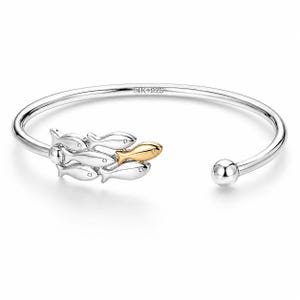 May include: Silver-tone open cuff bracelet featuring a school of fish. The fish are silver with one gold-tone fish. The bracelet has a smooth, polished finish and a small ball at the open end. The bracelet is marked "14K4925".