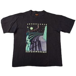 May include: Black Soundgarden Superunknown t-shirt. The graphic features a nighttime scene with a winding road, a bridge, and the band's name at the top. The words "SUPERUNKNOWN" are printed at the bottom of the graphic.