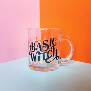 May include: A clear glass mug with a black and iridescent design that says "Basic Witch".