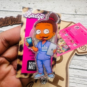 May include: A badge featuring a cartoon social worker holding a tablet and smartphone. The badge has a leopard print background with the word "Badge" at the top. The text "SCAN ME!" is visible on the badge.