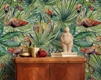 May include: A wooden cabinet with two doors and a light brown finish. The cabinet is decorated with a tropical wallpaper featuring pink flamingos and green palm leaves.