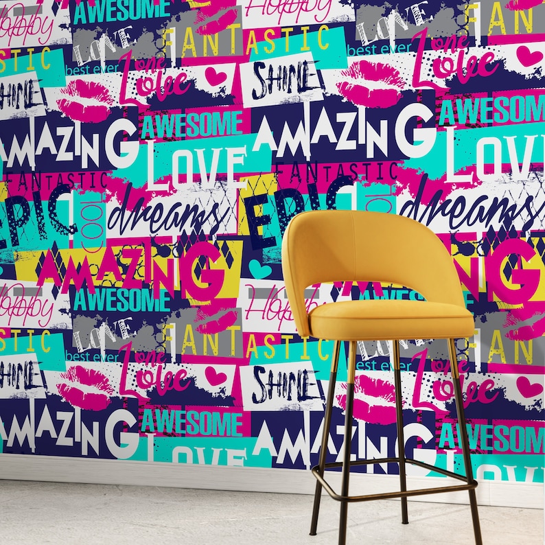 May include: A yellow bar stool with a black metal frame sits in front of a wall covered in colorful patterned wallpaper with words like "Amazing", "Love", "Fantastic", "Shine", and "Dreams".
