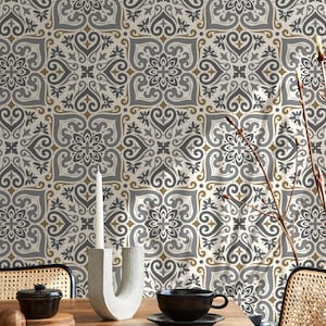 May include: A dining room setting with a wooden table, a black teacup and saucer, a small black bowl, and a modern candle holder. The background features patterned wallpaper in grey, white, and gold.