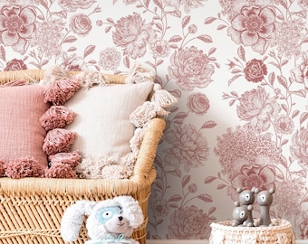 May include: A room scene featuring a floral wallpaper in shades of pink and white. A wicker basket holds pillows with tassels. A plush toy dog with a superhero mask and cape sits nearby. A small basket holds wooden toy bears.