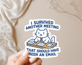 May include: A white sticker featuring a cartoon cat in a red tie, looking sad at a desk with papers. The sticker has the text: "I SURVIVED ANOTHER MEETING THAT SHOULD HAVE BEEN AN EMAIL."