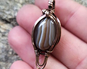 Purple and white banded Botswana Agate in polished copper wirewrapping