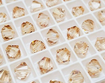 8 mm Kryształowe koraliki Crystal Golden Shadow Swarovski Crystal Article 5328 Bicone, 12 szt.