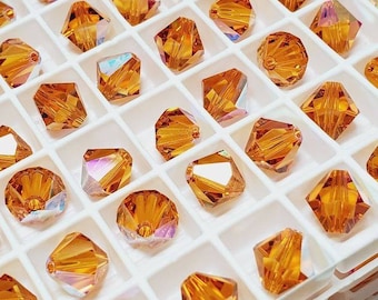 8 mm koraliki kryształowe Swarovski Topaz AB Bicone, 12 szt.
