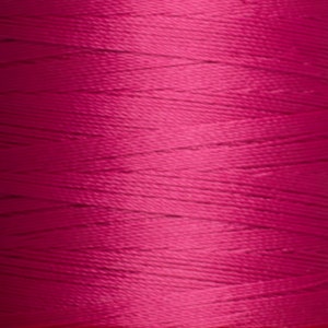 May include: A spool of bright pink thread.