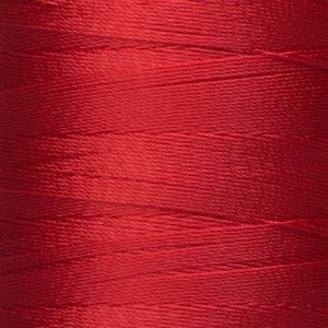 May include: A spool of red thread.