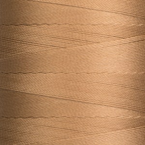 May include: A spool of tan thread.