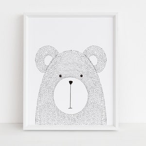 May include: A framed black and white illustration of a bear's face. The bear's body is filled with small dots, and it has large, round ears. The artwork is in a white frame, suitable for a nursery or children's room.