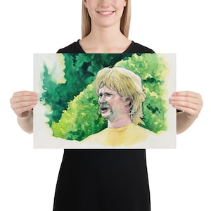 May include: A watercolor painting of a man with blonde hair and a mustache. He is wearing a yellow shirt and is surrounded by green foliage.