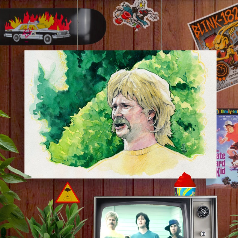 May include: A watercolor painting of a man with blonde hair and a mustache. He is wearing a yellow shirt and is standing in front of a green background. The painting is framed and hanging on a wall.