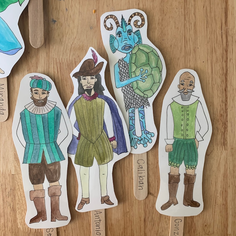 May include: Five illustrated character cutouts on sticks. The characters are a blue fish with a green turtle shell, a man with a green and white striped shirt, a man with a brown and green shirt, a man with a blue and green shirt, and a man with a green and white shirt. The sticks have the names of the characters written on them: Caliban, Antonio, Gonzalo, Miranda, and Sebastian.