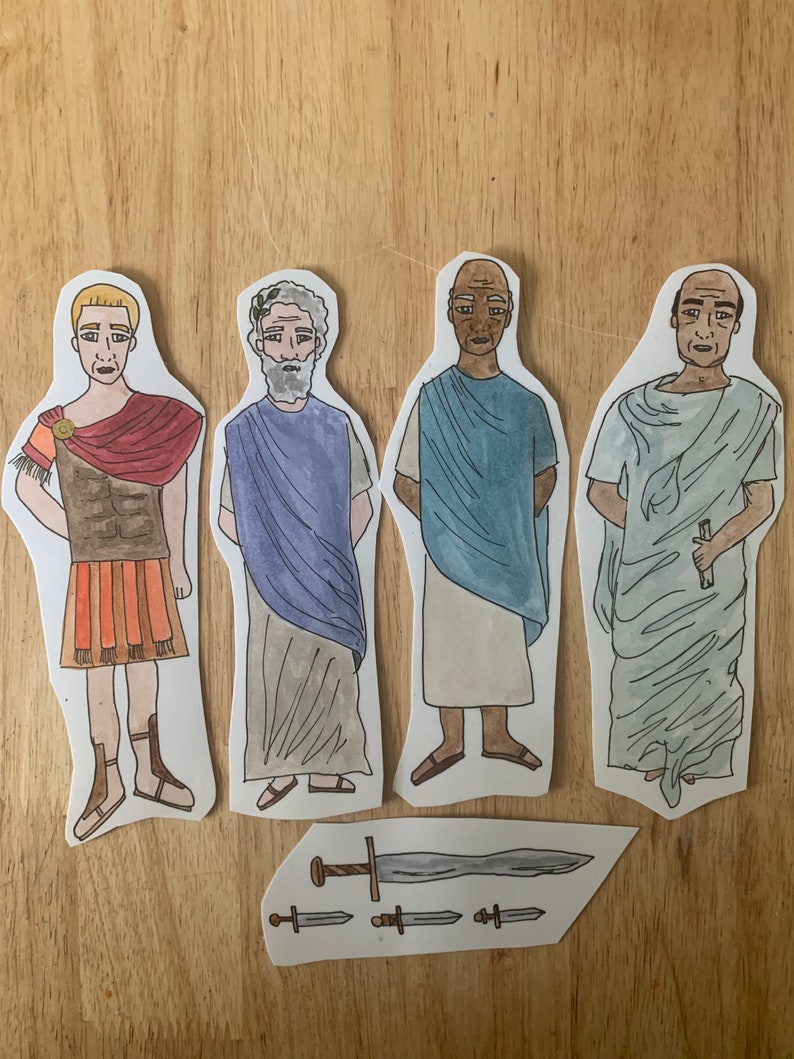 May include: Four paper cutouts of men in different historical costumes. The men are wearing a Roman soldier outfit, a toga, a blue tunic, and a white toga. There are also four paper cutouts of swords.