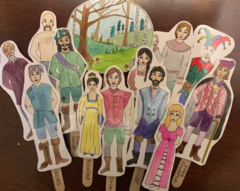 May include: A set of 11 hand-painted character illustrations on wooden sticks. The characters are dressed in various costumes and have different facial expressions. The illustrations are set against a backdrop of a forest scene.