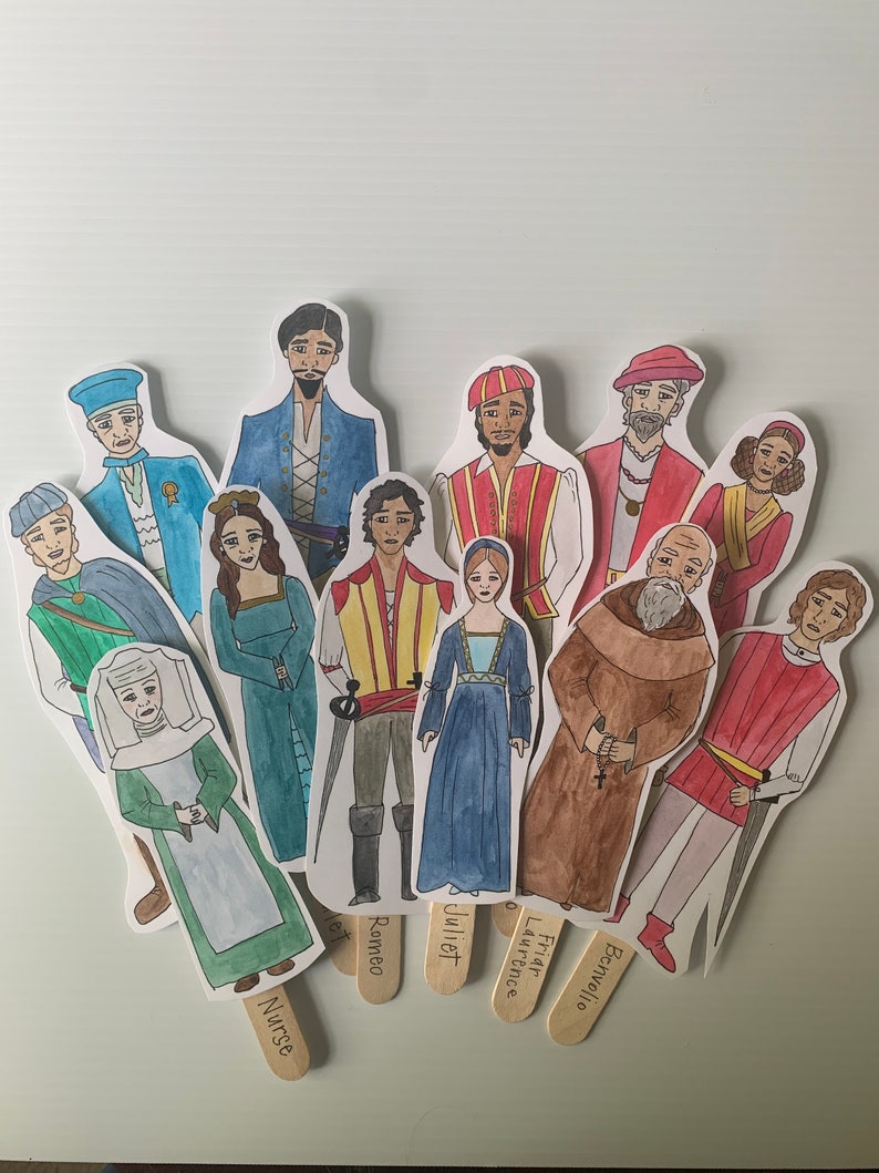 May include: A set of 12 hand-painted paper dolls depicting characters from Romeo and Juliet. Each doll is on a stick with the character's name written below. The dolls are dressed in colorful Renaissance-era clothing.