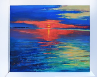 May include: An original oil painting of a sunset over water. The sky transitions from deep blue to vibrant red and orange, with the sun's reflection shimmering on the water's surface. The artwork is framed in a white border.