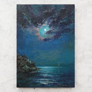 May include: An oil painting on canvas depicting a night seascape with a full moon shining through dark, textured clouds. A small sailboat floats on the deep blue water near a rocky cliffside. The brushstrokes are thick and visible throughout.