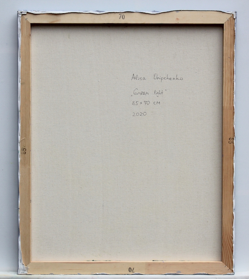 May include: The back of a framed canvas painting with the artist's signature, title, size, and date. The signature reads "Alisa Ovchpenko" and the title is "Green light". The size is 85 x 70 cm and the date is 2020.
