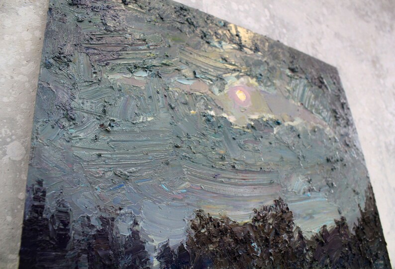 May include: Oil painting on canvas depicting a landscape with a textured, impasto style. The artwork features a dusky sky with a soft, yellow sun peeking through clouds. Dark trees are visible at the bottom, with shades of gray, blue, and brown.