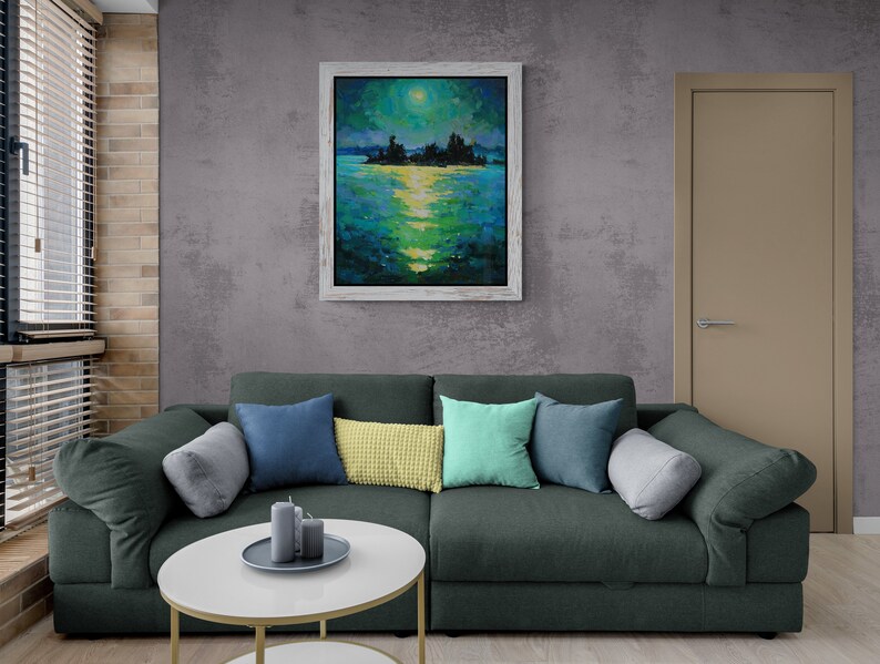 May include: A dark green sectional sofa with a variety of throw pillows in shades of blue, green, and yellow. The sofa is positioned in front of a gray wall with a framed painting of a moonlit lake scene.