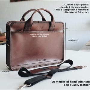 May include: Brown leather briefcase with a top handle and adjustable shoulder strap. The bag measures 36cm wide by 26cm tall. It features a front zipper pocket and a large main pocket that can fit a laptop up to 36cm in diameter. The bag is made of top quality leather and has 50 metres of hand stitching.