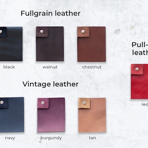 May include: Leather swatches in various colours and textures, including full grain, pull-up, and vintage leather. The swatches are labelled with their respective names: black, walnut, chestnut, red, navy, burgundy, and tan.