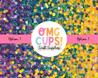 May include: A close-up of a multi-colored glitter mix with purple, green, gold, and white glitter. The glitter is arranged in a diagonal pattern. The image includes the text "OMG CUPS! Craft Supplies" in a white circle with a pink outline.