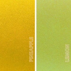 May include: A split image with a vertical white line separating two sections. The left side is a shimmering gold color with the word "PINEAPPLE" in white text. The right side is a shimmering light green color with the word "LEMON" in white text.