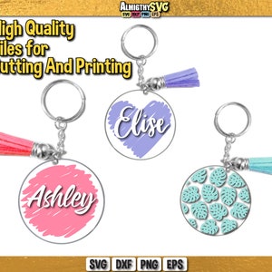 May include: Three keychains with different designs. The first keychain has a pink circle with the name "Ashley" written in white. The second keychain has a purple circle with the name "Elise" written in white. The third keychain has a white circle with a teal pattern of leaves.