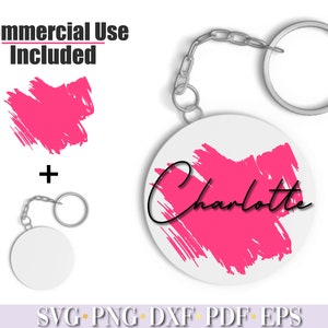 Pode incluir: Um chaveiro rosa e branco com o nome "Charlotte" escrito em it&aacute;lico preto. O chaveiro apresenta um design de pinceladas rosa e vem com um chaveiro prateado.