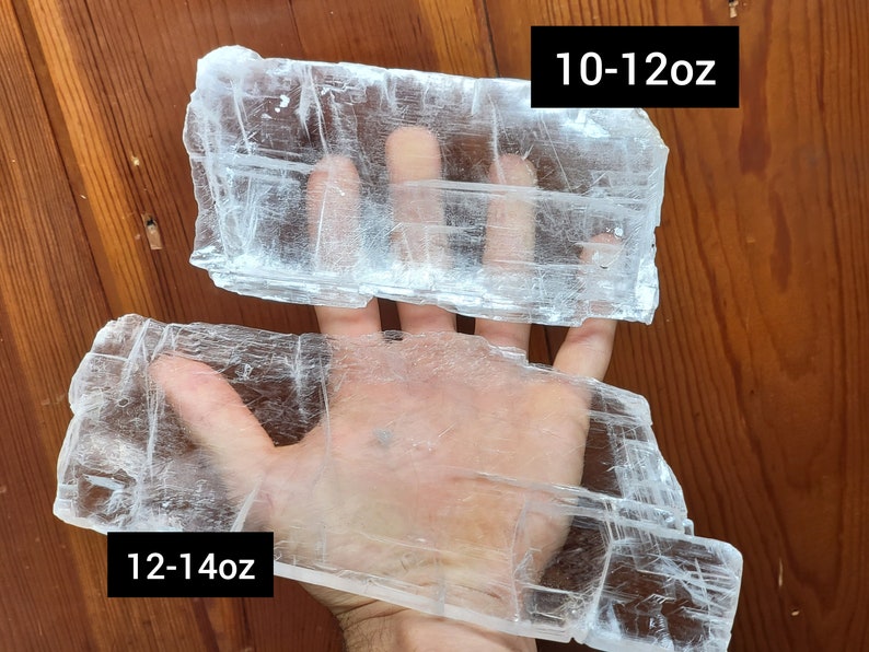 May include: Two pieces of clear selenite crystal, one is 10-12 oz and the other is 12-14 oz.