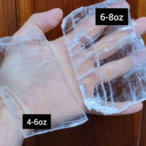 May include: Two pieces of clear selenite crystal, one labeled "4-6oz" and the other labeled "6-8oz".
