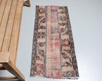 May include: A vintage runner rug with a floral pattern in shades of pink, red, blue, and beige. The rug has a fringed edge and is approximately 2 feet wide and 6 feet long.
