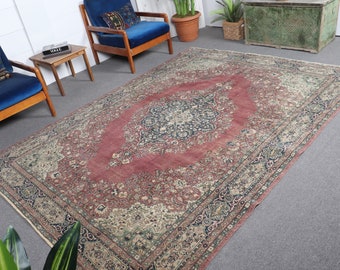 May include: A vintage Persian rug with a red background and intricate floral patterns in shades of cream, blue, and green. The rug has a faded, distressed look, adding to its antique charm.