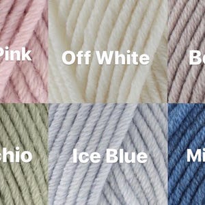 May include: Six yarn skeins in different colors: pale pink, off white, beige, pistachio, ice blue, and mid blue.