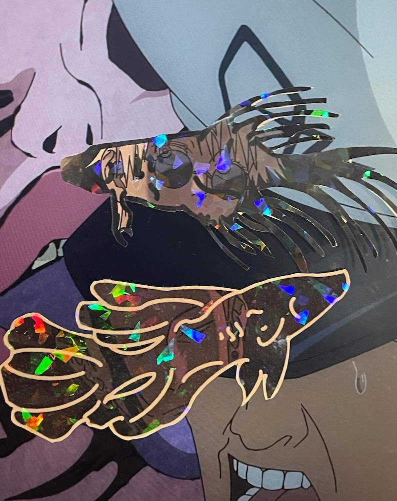 May include: Two holographic stickers featuring anime-style illustrations. One depicts a detailed creature with spiky fins and the other shows a stylized fish with a smiling face. Both stickers have a reflective, iridescent finish.