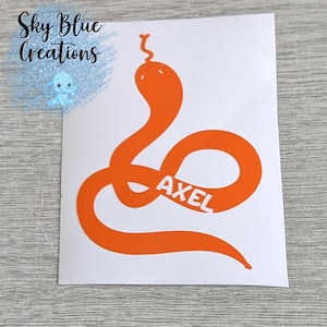May include: Orange vinyl sticker of a snake with the name Axel written inside the snake's body.