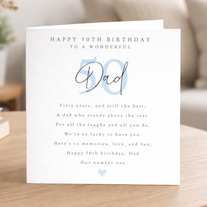 May include: A white square greeting card with the text HAPPY 50TH BIRTHDAY TO A WONDERFUL, a large light blue number 50, the word Dad in black script, and a poem about a 50th birthday. A small light blue heart is printed at the bottom center.