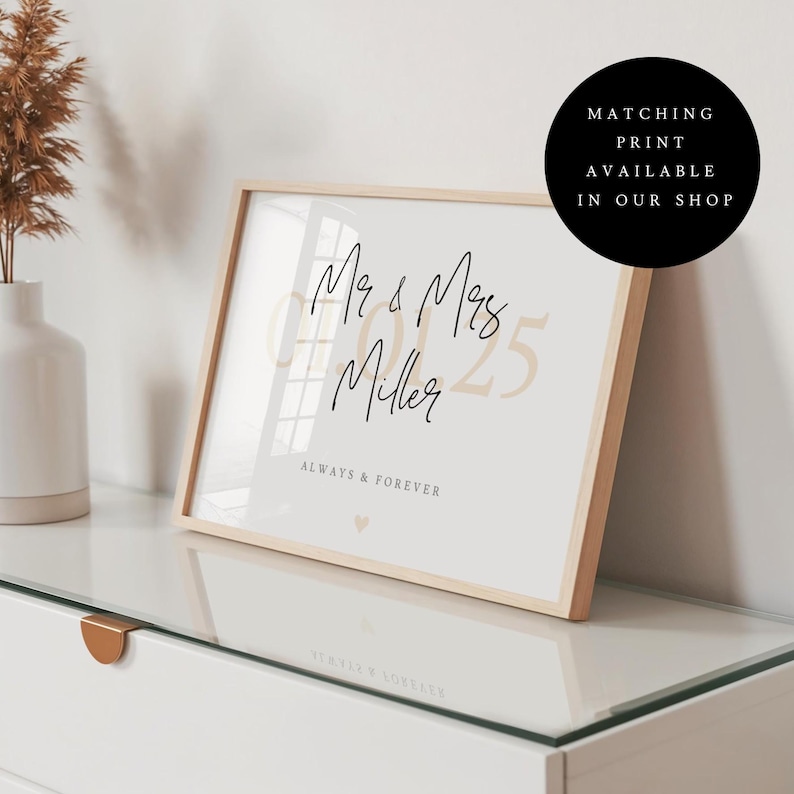 May include: A framed print in a light wood frame featuring the text Mr & Mrs Miller, the date 07.01.25 in large beige font, and the text ALWAYS & FOREVER with a small heart icon. A black circular badge states MATCHING PRINT AVAILABLE IN OUR SHOP.
