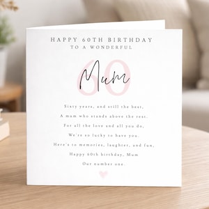 May include: A white square greeting card with black text that reads Happy 60th Birthday to a wonderful Mum. The design features a large, pale pink number 60 behind the word Mum in black script, followed by a birthday poem and a small pink heart.
