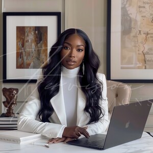 a black woman with long wavy hair brazilian hd wig, wearing a white suit with a white turtle neck, she is seating on a chair and leaning on a creme desk, on the table there is a laptop mockup, on the wall there is a black framed mockup