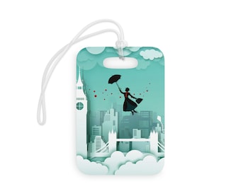 May include: A luggage tag featuring a silhouette of a woman flying with an umbrella over a paper-cut style cityscape of London, including Big Ben and Tower Bridge. The background is a light blue with white clouds.