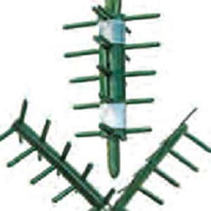 May include: Green floral foam with multiple prongs for arranging flowers. The foam is wrapped in a white plastic mesh.