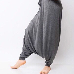 May include: Gray, loose-fitting pants with a drawstring waist. The pants are made of a soft, comfortable fabric and have a relaxed fit.