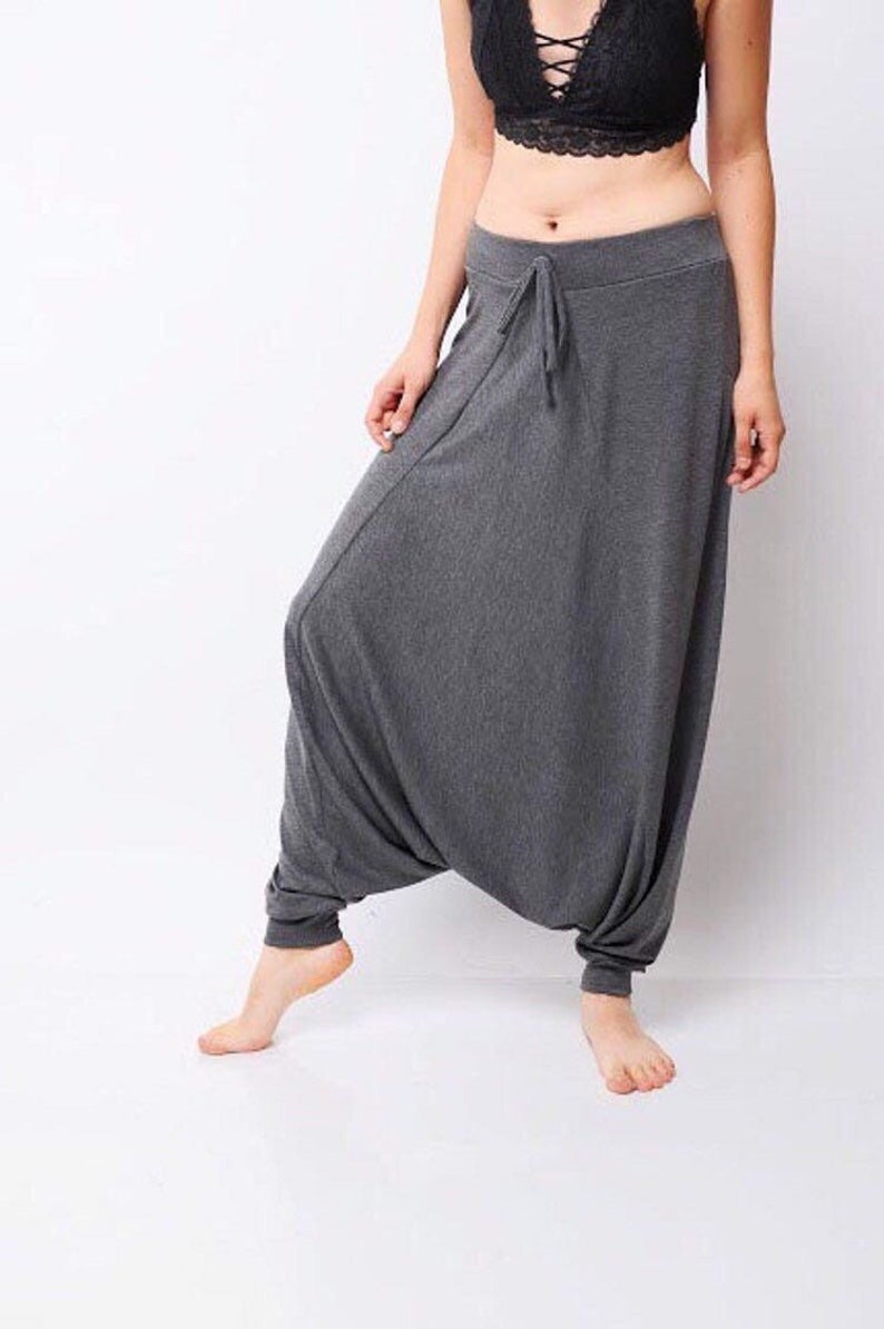 May include: Gray, loose-fitting pants with a drawstring waist. The pants are made of a soft, comfortable fabric and have a relaxed fit.